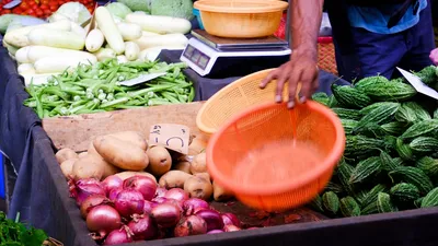 Whole and sliced bitter melon on a cutting board