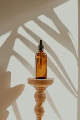Myrtle plant leaves and essential oil bottle on a wooden surface