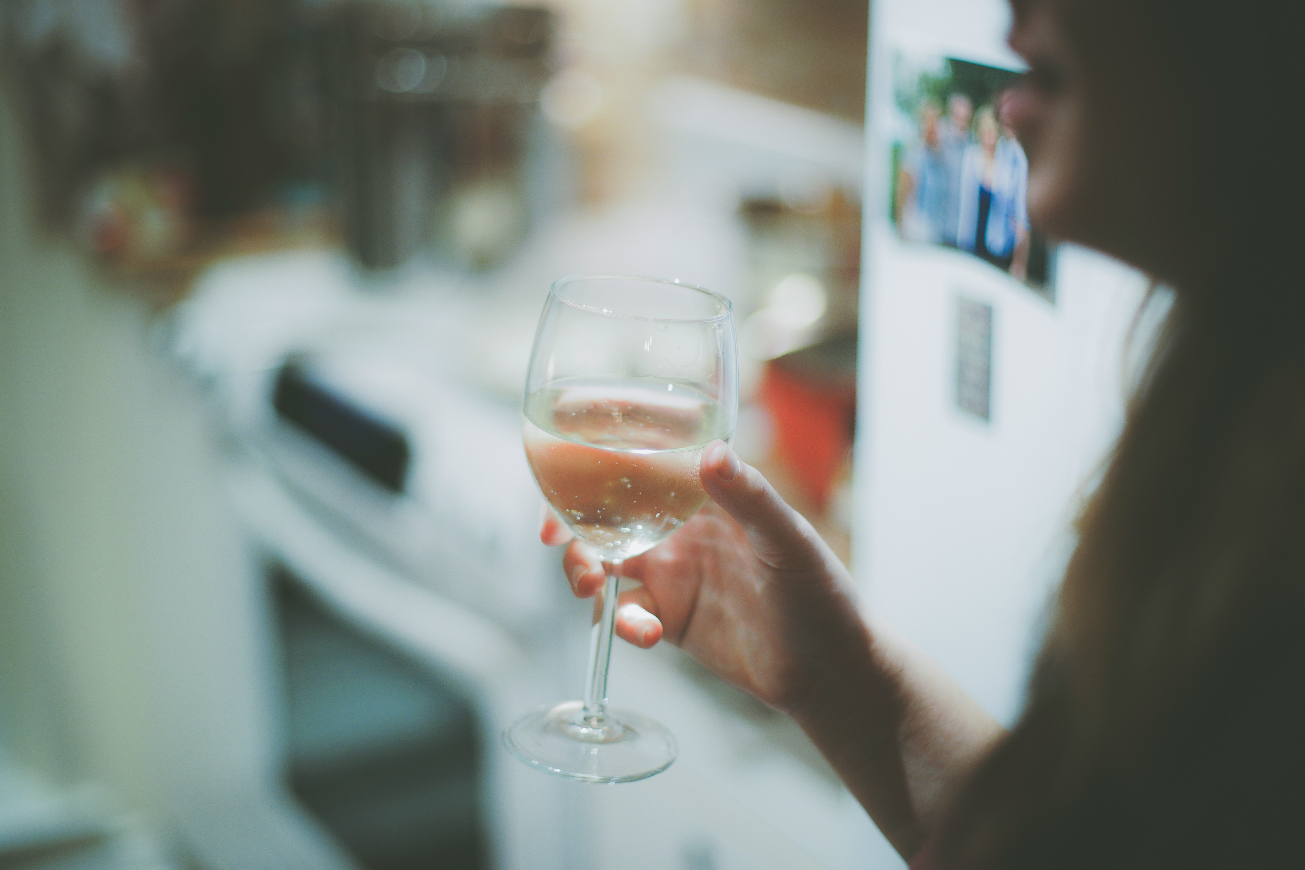 Wine glass and water glass side by side on a bar, representing alcohol and UTI risk choices