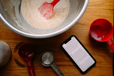 White powder in a ceramic bowl with a spoon on a clean surface