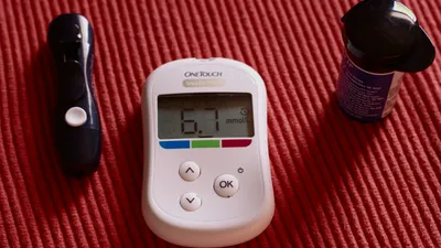 Glucose meter showing a blood sugar reading, illustrating the link between diabetes and bladder function