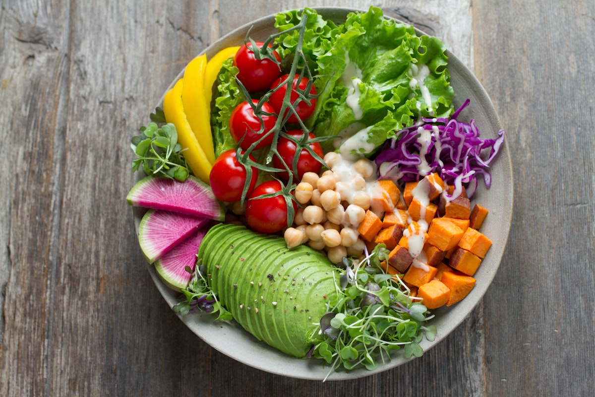 Bowl of high-fiber foods including vegetables, legumes, and whole grains that support gut microbiome and bladder health