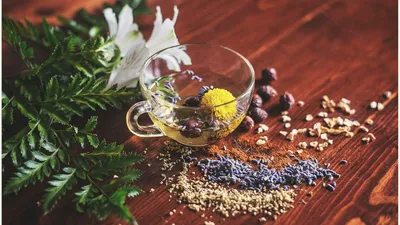 Two cups of herbal tea side by side, comparing horsetail and corn silk tea as natural diuretics