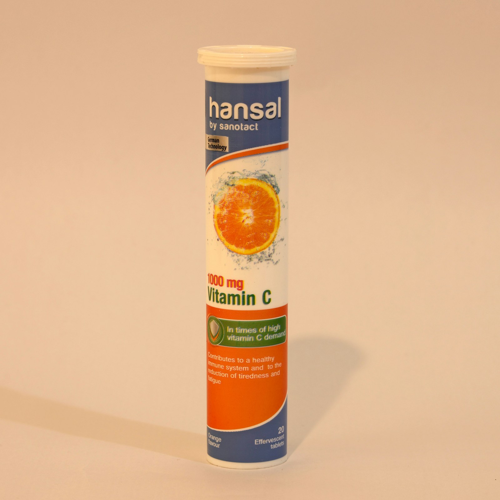 Vitamin C tablet next to a glass of water on a bedside table for evening UTI prevention dosing