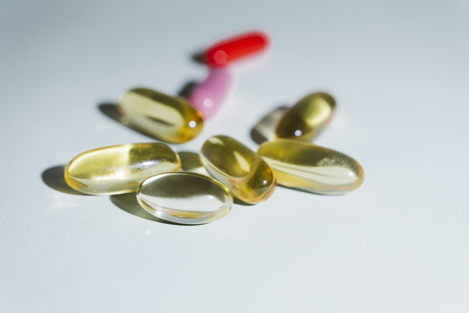 Vitamin D capsules and a blood test tube on a desk, illustrating testing for vitamin D deficiency and urinary incontinence risk